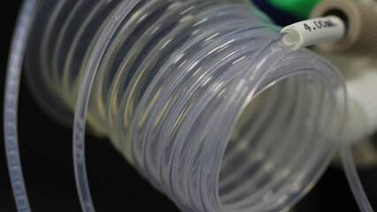 Poster - Liquid flows through a transparent pipe. special equipment in the laboratory for fluid transfer. Medical equipment for transfusion. fluid flows on the tube. a blood transfusion close up