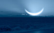 Ramadan concept - Crescent moon over the tropical sea wave at night 