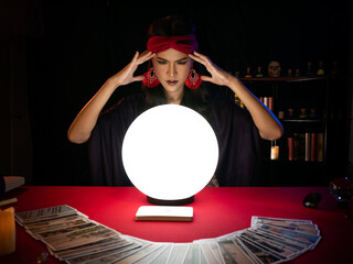 thailand - dec 19, 2019: asian beautiful fortune teller focus and use mental power on crystal ball a