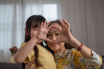 Portrait of a grandmother and granddaughter doing home activities and showing love for one another to create warmth and love within the family.