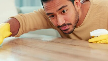 Poster - Closeup of a male sanitizing a surface and doing chores. A cleaner busy with housework for a neat, tidy and hygienic living space. Young man spraying and wiping a table while spring cleaning at home