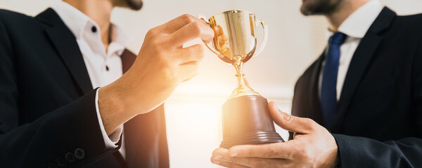 success business and achievement team concept, successful businessman holding champion award of winn