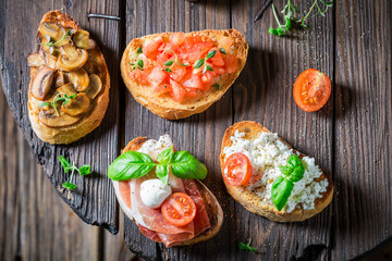 Wall Mural - Hot and tasty mix of bruschetta as classic snack.