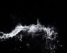 Water Splash In Air Drop Over Black Background, Studio Lighting High Speed