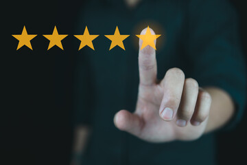 Customer review good rating concept hand pressing five star on visual screen and positive customer feedback testimonial.