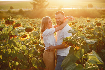 Wall Mural - People spend time in a sunflowers field