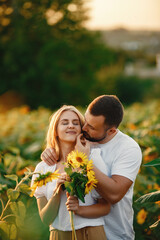 Wall Mural - People spend time in a sunflowers field