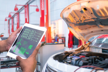 Wall Mural - Car Service Manager or Mechanic Uses a Tablet Computer with a Futuristic Interactive Diagnostics Software. Specialist Inspecting the Vehicle in Order to Find Broken Components In the Engine Bay