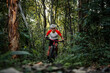 © VStudio - Mountain bikers ride MTB, mountain bike downhill to the extreme. Asian man rides MTB, mountain bike downhill in the wild to extremes. Extreme Sport and MTB, mountain bike downhill Concept.