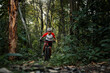 © VStudio - Mountain bikers ride MTB, mountain bike downhill to the extreme. Asian man rides MTB, mountain bike downhill in the wild to extremes. Extreme Sport and MTB, mountain bike downhill Concept.
