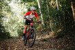 © VStudio - Mountain bikers ride MTB, mountain bike downhill to the extreme. Asian man rides MTB, mountain bike downhill in the wild to extremes. Extreme Sport and MTB, mountain bike downhill Concept.