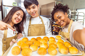 Wall Mural - Students In Cookery Class Mixing Ingredients For Recipe In Kitchen.Group of young people taking selfie during cooking classes.