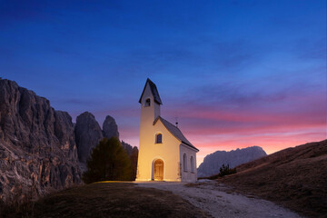 Wall Mural - incredible view on small iilluminated chapel - kapelle ciapela on gardena pass, italian dolomites mo