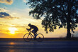 © Solid photos - Young sports man cycling with bicycle on the road in summer