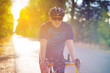 © Solid photos - Young sports man cycling with bicycle on the road in summer