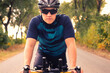 © Solid photos - Young sports man cycling with bicycle on the road in summer