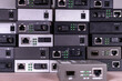© Климов Максим - Many media converters are stacked on top of each other. Technological background. selective focus