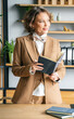 © velirina - Confident stylish mature middle aged elderly woman in office. General manager,ceo. Old senior businesswoman,60s lady in suit, executive business leader. Entrepreneur career.Accountant bank workplace