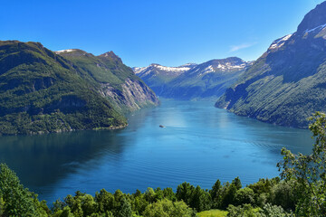 Cruise ship sailing mountains and ocean fjord landscape