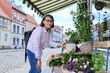 © Valerii Honcharuk - Woman shopping choosing pot with plant in store, on an outdoor rack