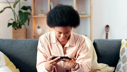 Wall Mural - Excited woman playing games on her phone, cheering and celebrating after completing a level. Young female gamer enjoying some multiplayer online gaming entertainment with wireless technology at home