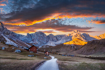Wall Mural - wooden cabins in fuchiade valley in italian dolomites countryside in autumn time. wooden huts, orang