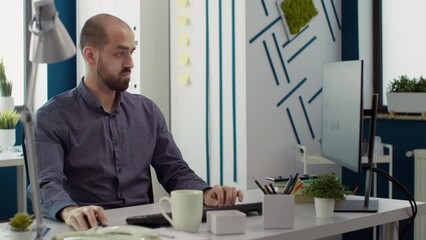Poster - Business man looking at financial statistics on computer to create development strategy in office. Executive assistant analyzing sales report on charts and graphs, doing research project.
