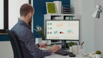 Poster - Male worker looking at text message on mobile phone app, taking break after working on financial statistics. Executive assistant using smartphone to browse internet and plan strategy.