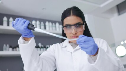 Aufkleber - Young female scientist doing research to find a cure for an illness or disease while working in a laboratory alone. Serious and expert medical biologist doing an experiment for progress in healthcare