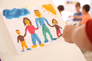 Sticker - Little child painting family indoors, closeup view