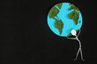 Human stick figure man carrying the earth on his shoulders on dark black background. Save planet earth, climate change responsibility, weigh and life burden concept.