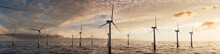 Wind Power. Offshore Wind Turbines At Sunset. Sustainable Energy Concept.