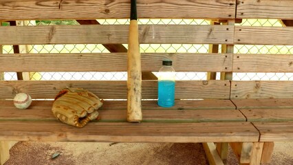 Wall Mural - Camera moves across baseball bench with ball, glove and bat