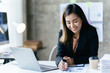 © PaeGAG - Asian woman working with laptop in her office. business financial concept.