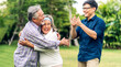 © Art_Photo - Portrait enjoy happy smiling love multi-generation asian big hug family.Senior mature father and elderly mother with young adult man son outdoor in park at home.insurance concept