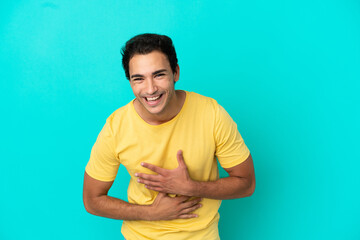 Wall Mural - Caucasian handsome man over isolated blue background smiling a lot