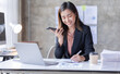 © David - Young Business asian woman talking on smartphone and working in office. Asian female Business sitting at his workplace.