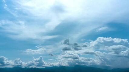 Wall Mural - Aerial view of the blue sky with white clouds in summer day. Time lapse of white clouds and sunny blue skies. Natural background in motion. drone shooting clouds motion time