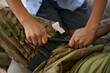 Boy turning handle to tighten tourniquet on army man leg