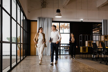 Business Colleagues Walking Together In Modern Office