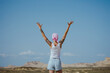 © Westend61 - Woman with arms raised standing in Bardenas desert, Spain