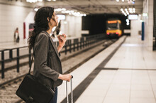 Transgender Businesswoman Wearing Blazer Talking On Phone Standing At Subway Station