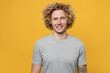 © ViDi Studio - Young smiling happy fun cheerful cool blond caucasian european man 20s he wearing basic grey t-shirt lookig camera isolated on plain yellow color backround studio portrait. People lifestyle concept.