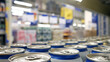 Close-up of many white-blue cans of beer or another drink on a store shelf