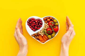 Wall Mural - Hands with heart shaped dish of healthy diet food