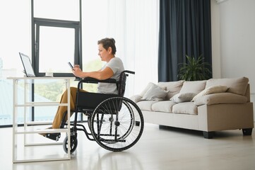 Poster - Positive elderly woman in wheelchair working on laptop, IT freelancer, online