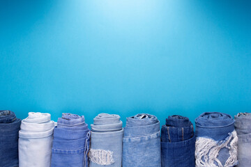 Wall Mural - Folded blue jeans denim on paper background texture. Jeans fabric material