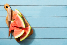 Fresh Watermelon Slices On Blue Wooden Table. Top View. Copy Space