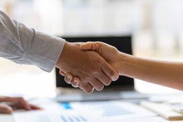 Wall Mural - Handshake. Financial advisors and accountants shaking hands at the meeting. The concept of working together for people in the organization.