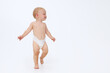 Cute little baby in a diaper on a white isolated background